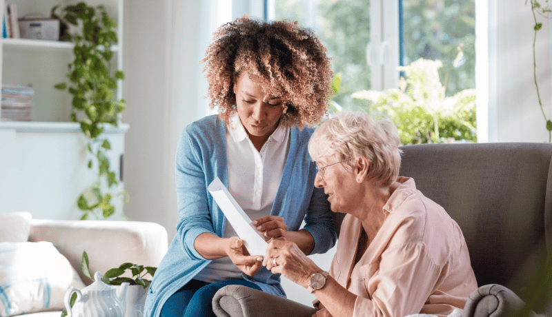 Caregiver going over paperwork with senior